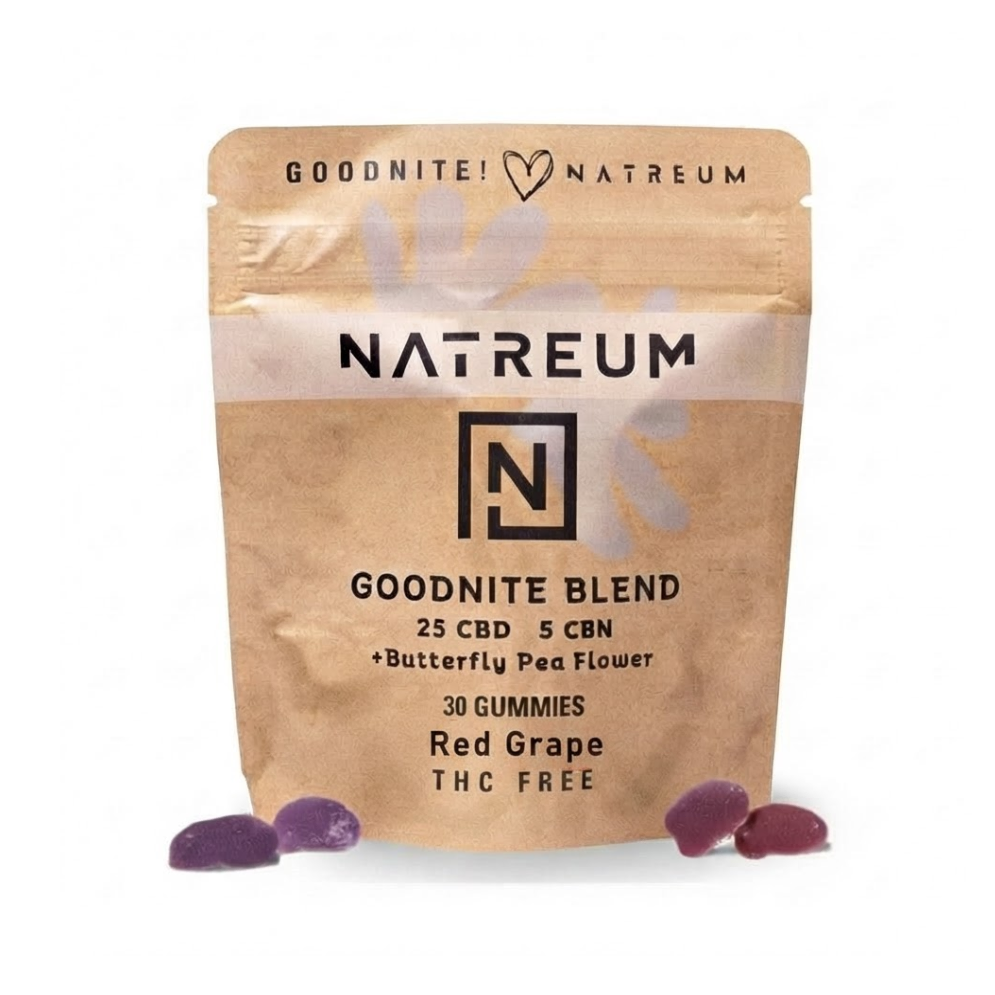 A stand-up pouch of NATREUM Goodnite Blend CBD gummies in Red Grape flavor, shown on a plain white background with three purple gummies placed in front.
