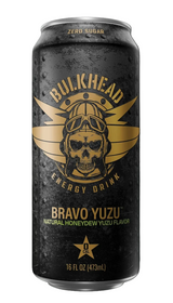 A single can of Bulkhead Energy Drink Bravo Yuzu flavor on a black background. The can is dark gray/black with a distressed texture, featuring a gold skull wearing a helmet and goggles with wings, and gold text.